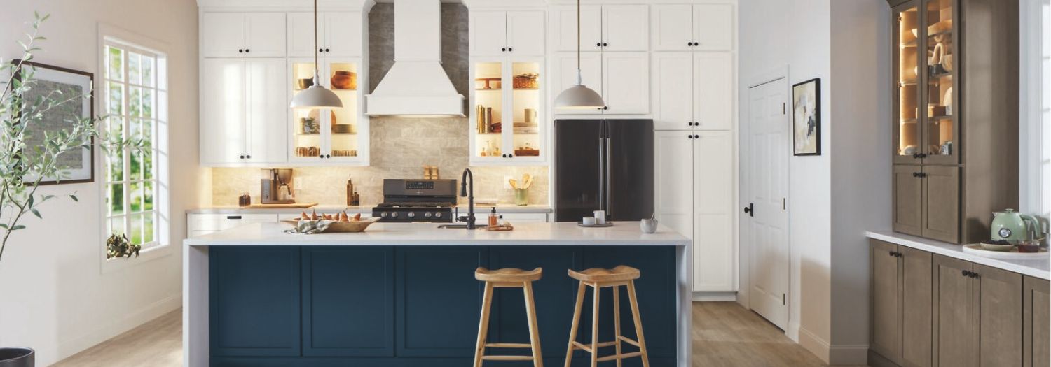 A beautiful kitchen with white cabinets and a blue island