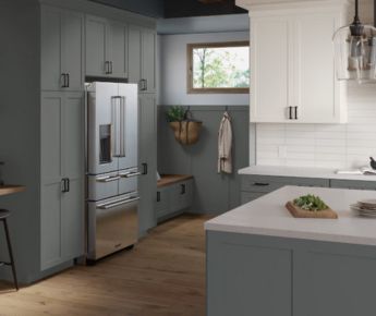 A beautiful kitchen with grey blue and white cabinets